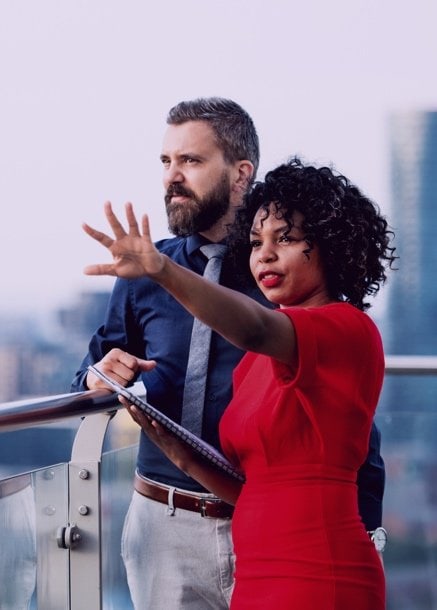 man and woman discussing plans woman with arm outstretched