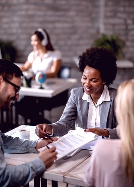Happy professionals discussing paperwork