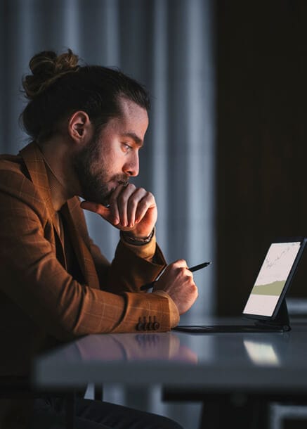 guy looking at cryptocurrency charts on computer